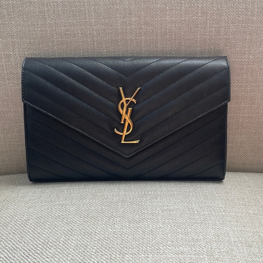 YSL cassandre chain wallet in black with gold hardware.
